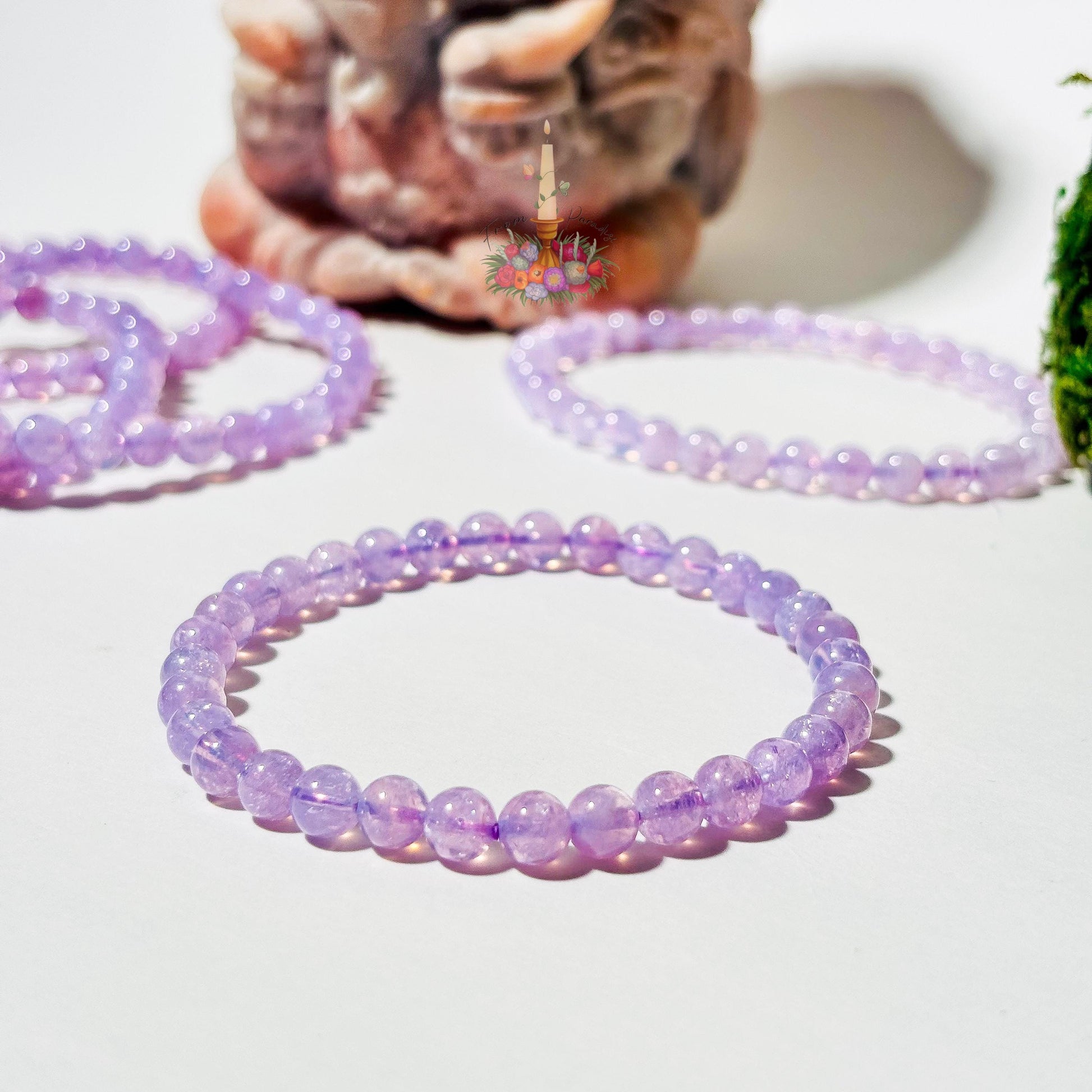 Lavender moon quartz crystal bracelet close up against white background.